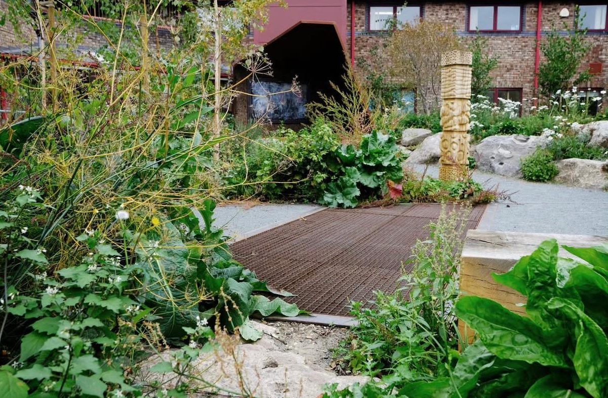 Corten steel arch over the garden path